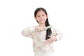 Smiling asian little kid girl combing long hair on white. Hair care concept