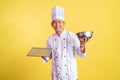 smiling asian male chef holding bread tray with mixing bowl Royalty Free Stock Photo