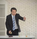 Smiling asian man in black suit with wooden gavel in hand wait people bidding auction concept Royalty Free Stock Photo