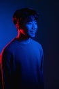 smiling asian man color light portrait neon blue Royalty Free Stock Photo