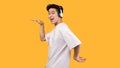 Smiling asian man enjoying music with headphones Royalty Free Stock Photo