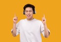 Smiling asian man enjoying music with headphones Royalty Free Stock Photo