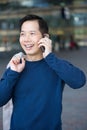 Smiling asian man with mobile phone Royalty Free Stock Photo