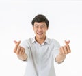 Smiling asian man showing fingers heart symbol and gesture