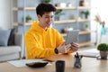 Smiling asian man using digital tablet at home Royalty Free Stock Photo