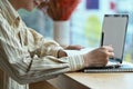 Smiling man using laptop and making notes on notepad. Royalty Free Stock Photo