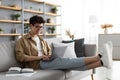 Smiling asian man win glasses orking on laptop at home Royalty Free Stock Photo