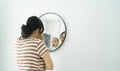 Asian mother holding little baby boy looking at mirror Royalty Free Stock Photo