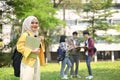 Smiling Asian Muslim female college student carrying her laptop and backpack Royalty Free Stock Photo