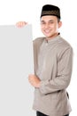 Smiling asian muslim man holding blank board Royalty Free Stock Photo