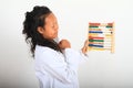 Smiling Asian scientist in lab coat counting on abacus