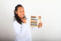 Smiling Asian scientist in lab coat counting on abacus