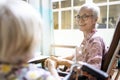 Smiling asian senior woman is happy to accidentally meet her close friend or good old friends in the hospital,elderly patients in Royalty Free Stock Photo