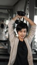 Smiling Asian short hair woman fitness dumbbell lifting. exercise Royalty Free Stock Photo