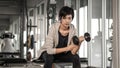 Smiling Asian short hair woman fitness dumbbell lifting. exercise