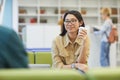 Smiling Asian Student in Library Royalty Free Stock Photo