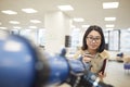 Smiling Asian Student Posing with Telescope