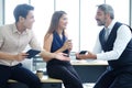 Smiling Asian team and Senior Caucasian boss is businesspeople teamwork relaxing and brainstorm. Businesswoman holding coffee Royalty Free Stock Photo