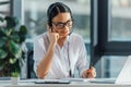 Smiling asian translator working online with Royalty Free Stock Photo