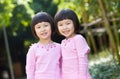 Smiling asian twin girls