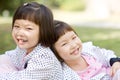 Smiling asian twin girls