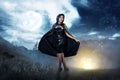 Smiling asian witch woman with black hooded cloak standing Royalty Free Stock Photo