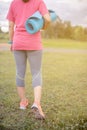 Smiling of Asian woman athlete an exercise and stretching in a field.