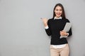 Smiling asian woman in business clothes holding laptop computer Royalty Free Stock Photo