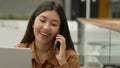 Smiling Asian woman businesswoman working online with laptop in office chinese japanese girl student freelancer talk Royalty Free Stock Photo