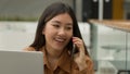 Smiling Asian woman businesswoman working online with laptop in office chinese japanese girl student freelancer talk Royalty Free Stock Photo