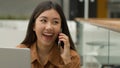 Smiling Asian woman businesswoman working online with laptop in office chinese japanese girl student freelancer talk Royalty Free Stock Photo