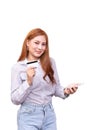 Smiling Asian woman in casual shirt holding mobile phone and showing credit card for shopping online Royalty Free Stock Photo