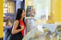 Smiling Asian woman choosing ice cream Royalty Free Stock Photo