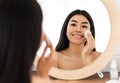 Smiling asian woman cleaning her face, using cotton pads Royalty Free Stock Photo