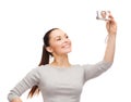 Smiling asian woman with digital camera Royalty Free Stock Photo