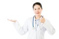 Smiling asian woman doctor display something and thumb up Royalty Free Stock Photo