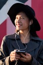 smiling asian woman with earphones and phone Royalty Free Stock Photo