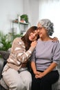 Smiling Asian woman embracing mature mother expressing unconditional love Royalty Free Stock Photo
