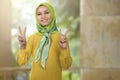 Smiling asian woman girl with hijab showing peace sign Royalty Free Stock Photo