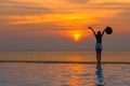 Smiling asian woman happy in big hat relaxing on the swimming pool, travel near the sea and beach in the sunset. Royalty Free Stock Photo