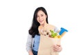 Smiling Asian woman holding grocery shopping bag Royalty Free Stock Photo