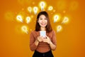 smiling Asian woman holding mobile phone with lightbulb icon and dollar sign  idea for make money online  e-business concept Royalty Free Stock Photo