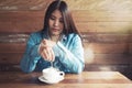 Smiling asian woman with hot coffee cup at coffee shop. Royalty Free Stock Photo