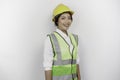 A smiling Asian woman labor wearing safety helmet and vest, isolated by white background. Labor\'s day concept