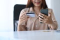 Smiling woman making online banking or shopping online on her smart phone. Royalty Free Stock Photo