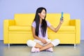 Smiling asian woman making video call by cell phone talking with friends or family Royalty Free Stock Photo
