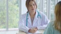 Smiling Asian woman pediatrician give advice to patients , Young asia female doctor consult female patient and checkup in hospital Royalty Free Stock Photo