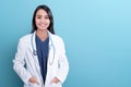 Smiling asian woman physician in a white coat