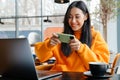 Smiling asian woman playing online game on cellphone Royalty Free Stock Photo