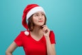 Smiling asian woman portrait with christmas santa hat thinking i Royalty Free Stock Photo